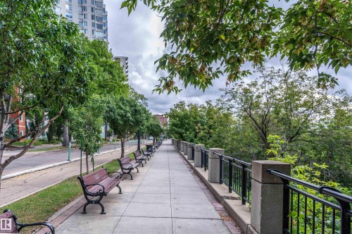 Pedestrian pathway lined with park benches and mature trees - #1202 10010 119 St Nw, Edmonton, AB 
