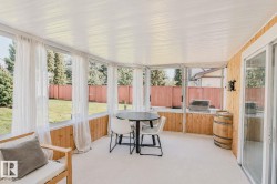 Enclosed patio with wood-paneled walls, white paneled ceiling, and glass sliding doors - 
