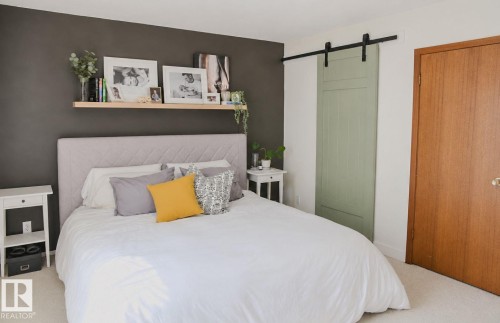 Wall-mounted floating shelf, barn door with black hardware, and wood-finish interior door - 3911 117 Street Nw, Edmonton, AB 