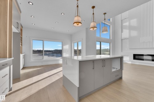 Kitchen island with light grey cabinetry and a solid surface countertop - 226 Linden Loop, Leduc, AB 