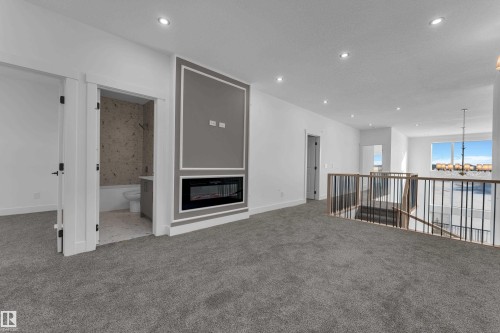 Upper-level bonus room with gray carpet flooring and recessed lighting - 226 Linden Loop, Leduc, AB 