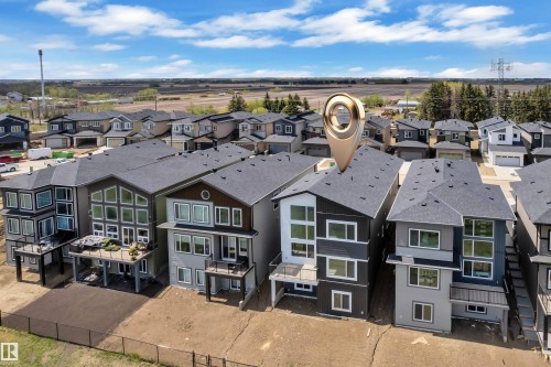 Modern construction featuring multi-level design and a dark shingle roof - 226 Linden Loop, Leduc, AB 