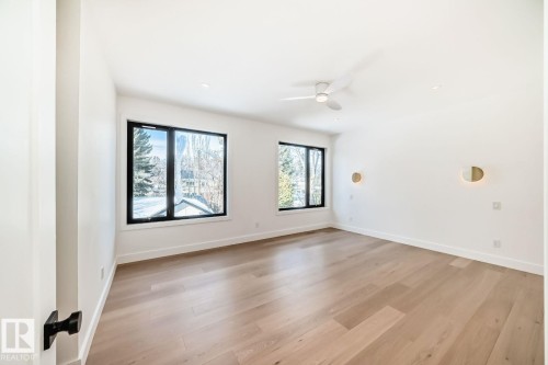 Light wood-finish flooring, recessed lighting, and a ceiling fan with integrated light - 10514 134 Street Nw, Edmonton, AB 