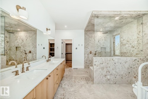 Dual vanity with light wood-finish cabinetry, white countertops, and brushed gold fixtures - 10514 134 Street Nw, Edmonton, AB 