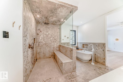 Walk-in shower with integrated bench seating, rainfall shower head, and a freestanding soaking tub - 10514 134 Street Nw, Edmonton, AB 