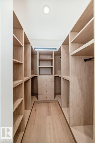Custom light wood-finish built-in shelving with integrated drawers - 10514 134 Street Nw, Edmonton, AB 
