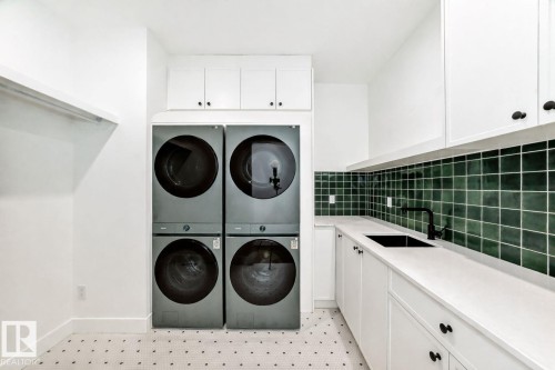 White shaker cabinetry, dark green subway tile backsplash, white countertop, integrated black sink, and black wall-mounted faucet - 10514 134 Street Nw, Edmonton, AB 