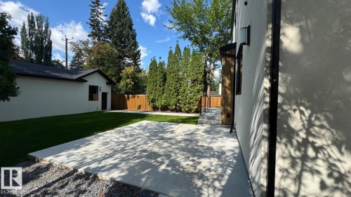 Expansive concrete patio with gravel border - 10514 134 Street Nw, Edmonton, AB 