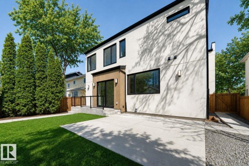 Modern architecture featuring a smooth stucco exterior and dark-framed windows - 10514 134 Street Nw, Edmonton, AB 