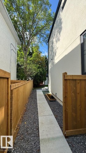 Gravel pathway with concrete stepping stones, leading between two structures - 10514 134 Street Nw, Edmonton, AB 