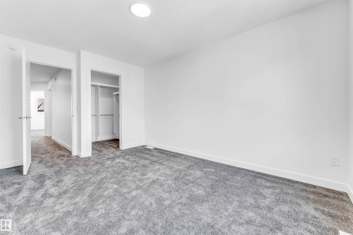 Plush gray carpeting throughout, built-in closet shelving, and a recessed ceiling light - #48 710 Mattson Dr Sw Sw, Edmonton, AB 