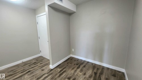 Wood-finish flooring, light neutral wall paint, and white trim throughout - #101 11803 22 Av Sw, Edmonton, AB 