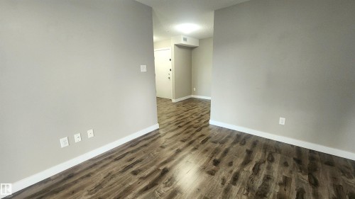 Wood-finish flooring throughout, light neutral wall paint, and white trim - #101 11803 22 Av Sw, Edmonton, AB 