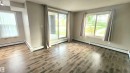 Wood-finish flooring throughout, complemented by light-toned wall paint - #101 11803 22 Av Sw, Edmonton, AB 
