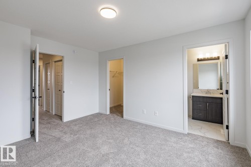 Spacious interior room with light gray carpet flooring and recessed ceiling lighting - 70 Dansereau Way, Beaumont, AB - Indoor