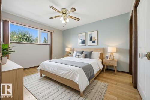 Hardwood flooring, light-toned walls, ceiling fan, and a window with a light-toned frame - 14008 94 Street Nw, Edmonton, AB 