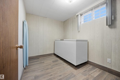 Wood-finish flooring, paneled wall finish, and a window with blinds - 14008 94 Street Nw, Edmonton, AB 