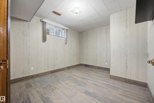 Wood-finish flooring, paneled walls, and a secure window - 14008 94 Street Nw, Edmonton, AB 