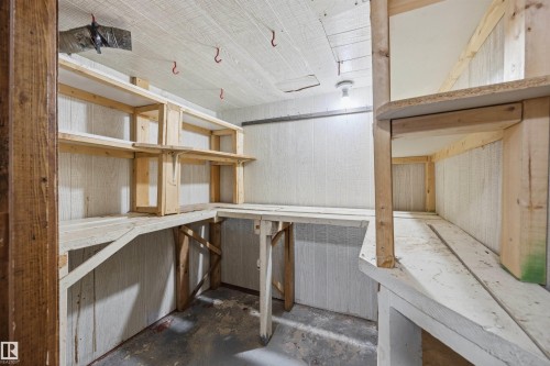 Built-in wooden shelving, durable wood-finish wall panels, and overhead lighting - 14008 94 Street Nw, Edmonton, AB 