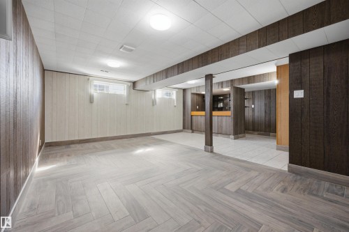 Herringbone wood-finish flooring, recessed lighting, wood paneling, and a built-in bar - 14008 94 Street Nw, Edmonton, AB 