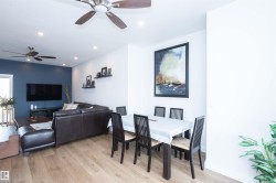 Open-concept living and dining area featuring wood-finish flooring, recessed lighting, and dual ceiling fans - 