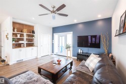 Living area featuring wood-finish flooring, recessed lighting, and a ceiling fan - 