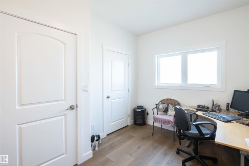 Bright room featuring wood-finish flooring, white walls, and a large window - 5404 60Th Street, Barrhead, AB - Indoor Photo Showing Office