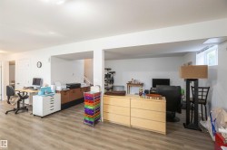 Expansive lower level featuring wood-finish flooring, recessed lighting, and white walls - 