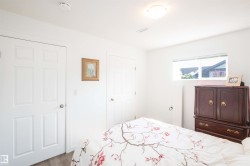 Interior room featuring white walls and a light wood-finish floor - 