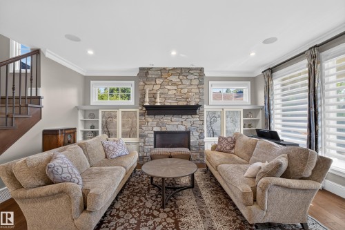 Natural stone feature fireplace with flanking built in Cabinets. - 14308 97A Avenue Nw, Edmonton, AB 