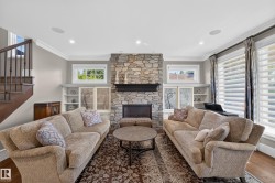 Natural stone feature fireplace with flanking built in Cabinets. - 