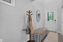 Entryway featuring a white door with decorative glass, light gray walls, and tile flooring - 5130 Godson Close Nw, Edmonton, AB 