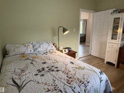 Light green wall paint complementing wood-finish flooring - 
