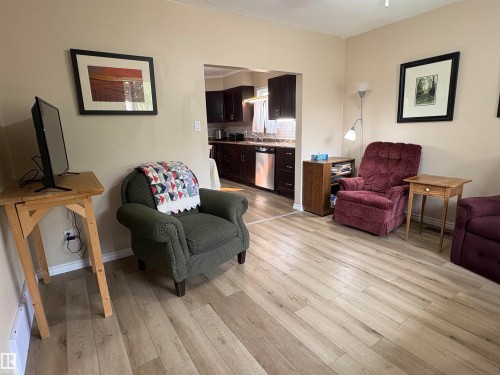 Open concept living area featuring light wood-finish flooring and neutral wall tones - 5308 50 St, Ryley, AB 