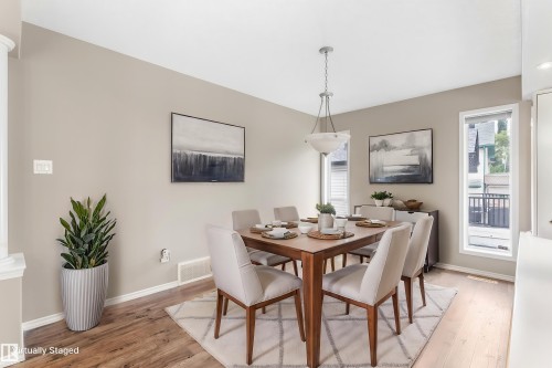 Recessed lighting, wood-finish flooring, and a contemporary chandelier - 2060 Brennan Crescent Nw, Edmonton, AB 