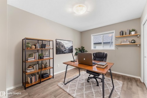 Wood-finish flooring, recessed lighting, built-in shelving, white trim, and a window for natural light - 2060 Brennan Crescent Nw, Edmonton, AB 
