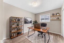 Wood-finish flooring, recessed lighting, built-in shelving, white trim, and a window for natural light - 