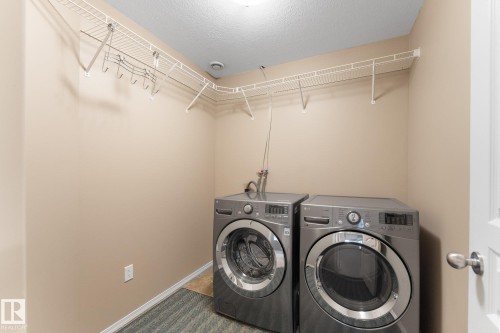 Laundry area featuring a wire rack storage system, integrated hanging bar, and existing appliance hookups - 2060 Brennan Crescent Nw, Edmonton, AB 