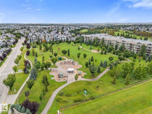 Expansive green space featuring a playground, walking paths, and mature trees - 2060 Brennan Crescent Nw, Edmonton, AB 
