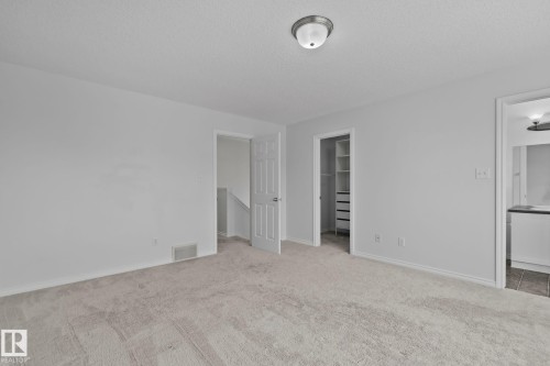 Wall-to-wall carpeting and neutral wall tones - 9523 Simpson Crest Nw, Edmonton, AB 