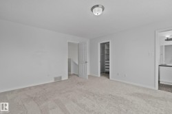 Wall-to-wall carpeting and neutral wall tones - 