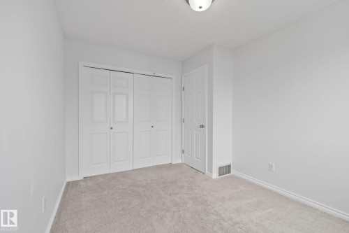 Neutral-toned carpeting with white trim - 9523 Simpson Crest Nw, Edmonton, AB 