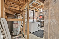 Laundry area featuring a washer, dryer, and water heater - 