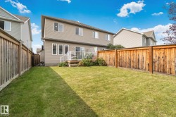 Expansive grassy yard with wood fencing - 