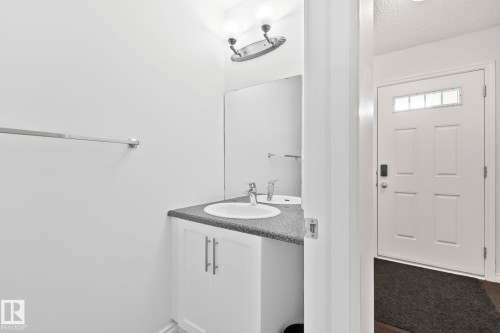 White paneled door with transom window - 9523 Simpson Crest Nw, Edmonton, AB 