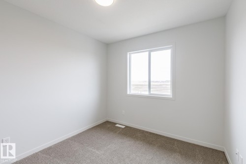 Neutral white walls with a single window and recessed ceiling light - 3603 40 Avenue, Beaumont, AB - Indoor Photo Showing Other Room