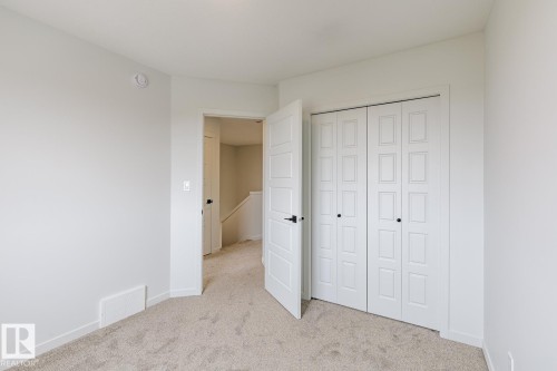 Neutral-toned wall paint with coordinating carpet flooring - 3603 40 Avenue, Beaumont, AB - Indoor