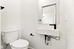 Wall-mounted rectangular sink with a matte black faucet and coordinating fixtures - 