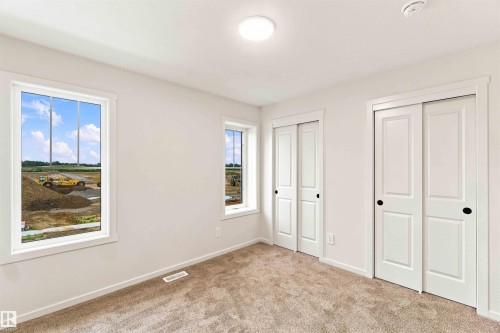 Bright interior with neutral carpeting - 7097 Rosenthal Drive Nw, Edmonton, AB 