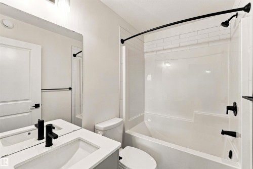 Vanity with integrated sink, matte black faucet, and white countertop - 7097 Rosenthal Drive Nw, Edmonton, AB 